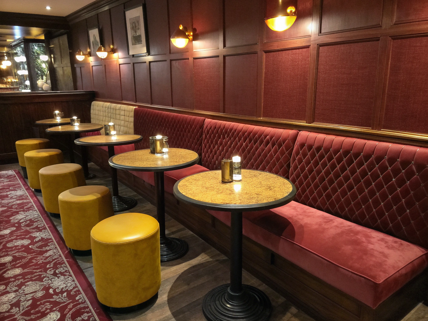 Cozy velvet banquette seating in a modern French restaurant